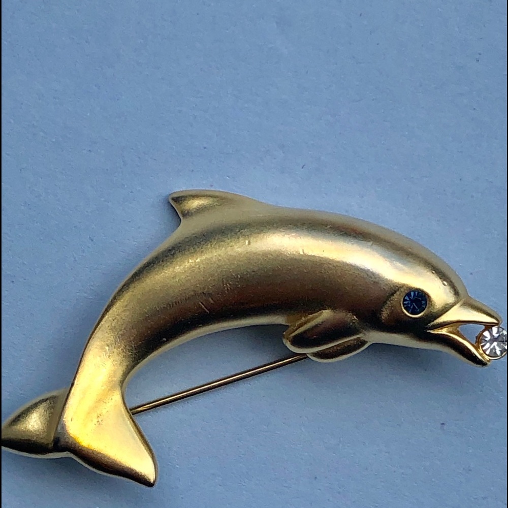 Dolphin pin gold tone. Signed. Brand new in box.